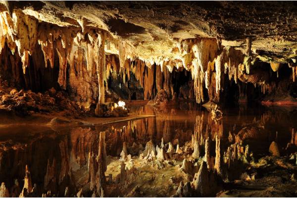 Cave stalactites and formations reflected in the water at Luray Caverns, Virginia.